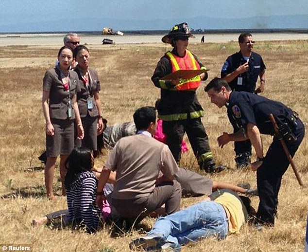 Rescue: Flight attendants help injured passengers. Two of the airline